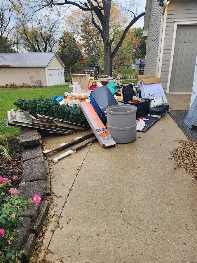 Dumpster being loaded with debris for Estate Cleanout Dumpster Rental in Lowville